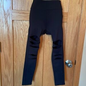 Girls leggings w/ rips in legs in black. Size 10/12 and in nice condition.
